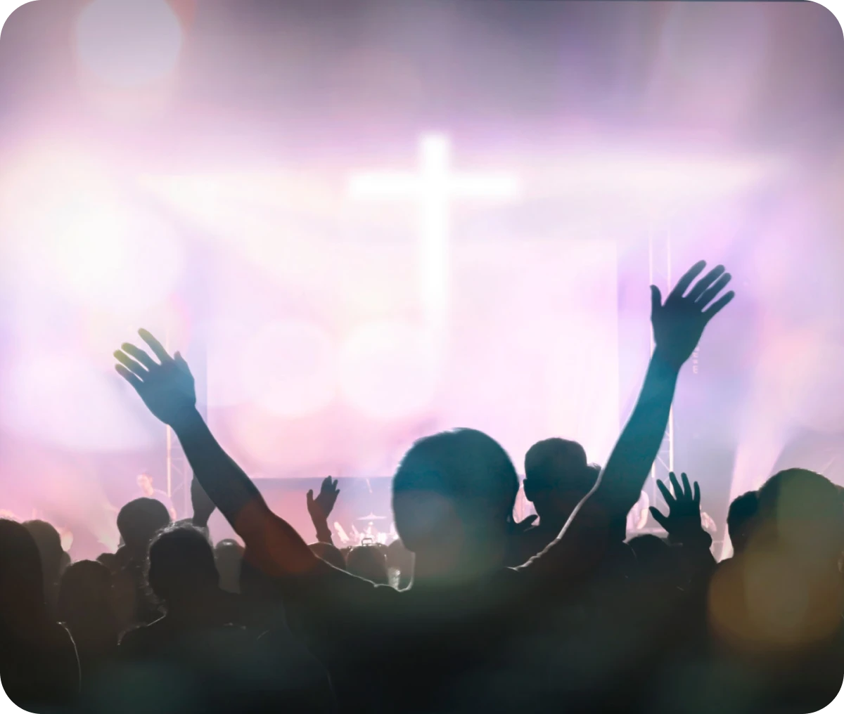 Silhouettes in spiritual gathering with cross