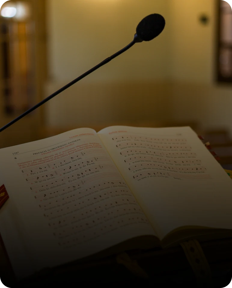 Church hymnal and microphone in dim lighting
