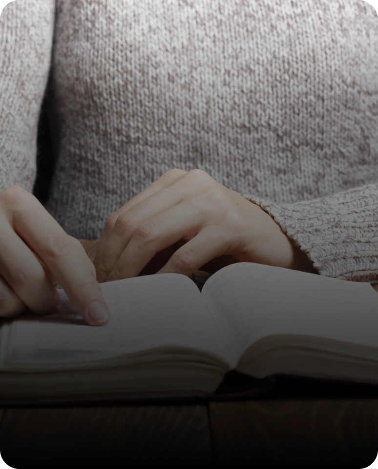 Close-up of hands on book pages